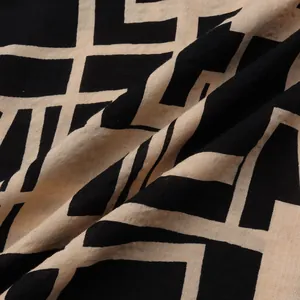 Close-up detail of lightweight men's shirt fabric with black and beige geometric grid pattern