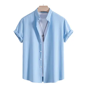 Light blue vertical textured men's short sleeve shirt layered with a white inner t-shirt