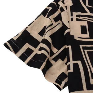 Detailed view of the geometric pattern and hem stitching on this men's short sleeve shirt.