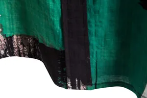 Close-up of green floral shirt showing lightweight linen texture and clean hem stitching