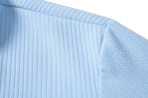 Detailed close-up showing the light blue textured fabric of a men's summer casual shirt
