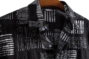 Macro view of black men's casual shirt with white floral print and fabric texture