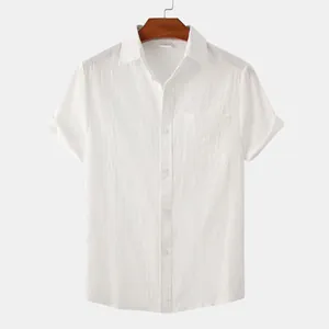 Detail view of a white cotton linen short sleeve shirt with a front pocket and lapel