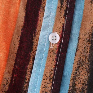 Close-up of cotton linen striped shirt detail showing white button and stitching texture