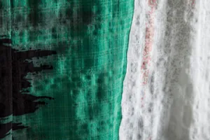 Macro detail of the breathable textured fabric on a men's casual floral summer shirt