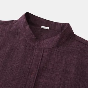 Close-up detail of a men's mandarin collar linen shirt showing deep plum fabric texture