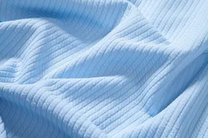 Close-up texture of light blue ribbed fabric detail for men's casual summer shirt