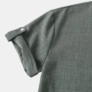 Primer plano de camisa de hombre de manga corta con tela verde texturizada y botón de puño