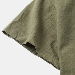 Macro view of olive green cotton linen fabric texture on men's short-sleeved shirt sleeve