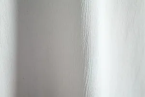 Macro shot of white linen-blend fabric texture for men's casual short sleeve shirt