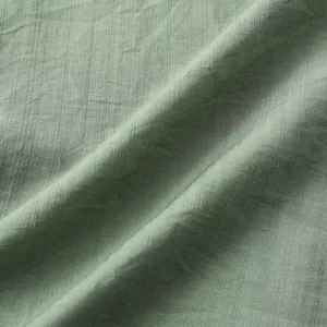 Macro detail van lichtgroene linnen textuur stof voor een zomers herenshirt casual