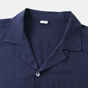 Close-up of a dark navy blue cotton linen shirt collar showing fine textured fabric detail
