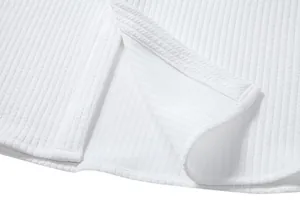 Close-up of white ribbed texture and hem stitching on men's summer casual shirt