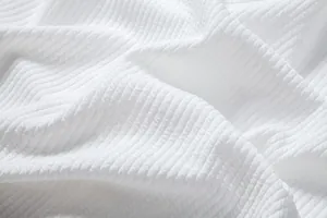 High-quality close-up detail of white ribbed fabric texture for men's summer casual shirt
