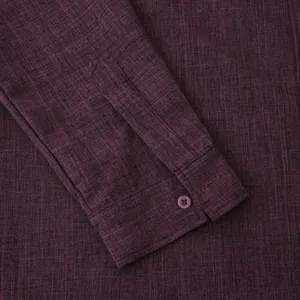 Close-up detail of men's burgundy cotton linen shirt cuff showcasing fine fabric texture