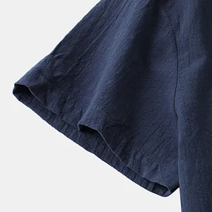 Detailed macro view showing the textured cotton linen fabric and stitching on shirt sleeve