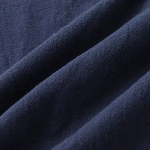 Detailed macro view of dark navy blue cotton linen fabric showing the soft woven texture