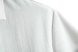 Close-up detail showing the premium crinkled fabric texture of this white casual shirt