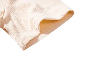 Close-up of beige men's casual shirt showing waffle texture and sleeve stitching
