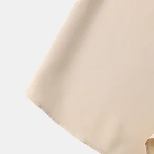 Primer plano detallado de la tela de la camisa beige para hombre con textura y costura