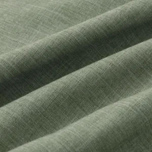 Primer plano macro de tela de algodón y lino verde con textura de tejido visible