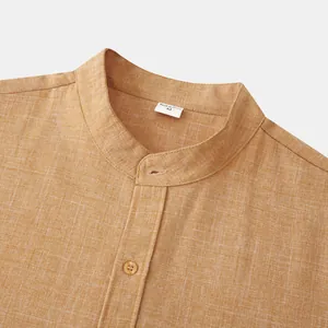 Detailed close-up of mustard cotton linen shirt showing stand collar and fabric texture