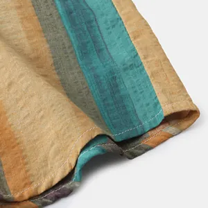 Close-up of a men's striped cotton linen shirt sleeve showing fine stitching and texture