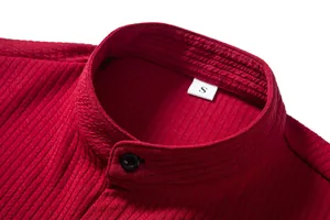 Detailed view of a red men's casual shirt collar with striped texture and size S label.