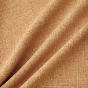 Detailed macro view of ochre cotton-linen fabric texture with natural weave pattern
