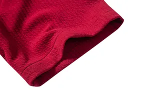 Macro view of burgundy textured fabric and stitching on a men's casual shirt