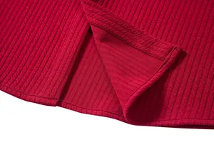 Detailed macro shot of a men's casual red ribbed shirt hem featuring a clean side split design