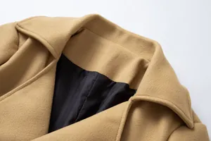 Detailed view of the notch lapel and black lining on a classic camel wool overcoat for men.