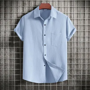 Detailed view of light blue men's short-sleeved casual shirt with textured fabric