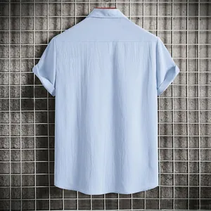 Back view of a men's light blue solid color short-sleeved casual shirt with textured fabric