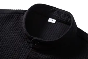 Close-up of black men's casual shirt showing ribbed texture and stand collar