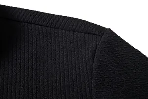 Macro view showing the detailed vertical ribbed texture of a black men's casual shirt