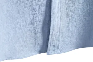 Macro view of light blue seersucker fabric and stitching on casual shirt