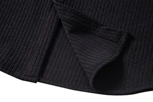 Detailed view of the black ribbed texture and hem stitching on a men's summer shirt