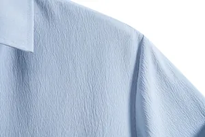 Detailed macro view showing the light blue seersucker fabric texture on this shirt