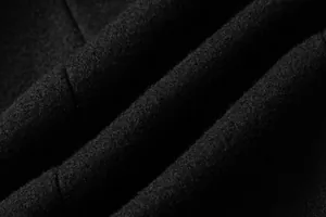 High-quality close-up of thick black wool fabric texture for men's winter overcoat