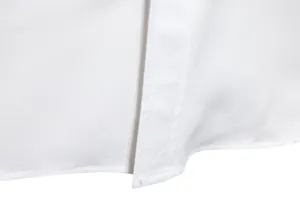 Close-up of neat stitching and hem on a white long-sleeved casual shirt.