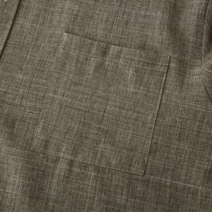 Close-up of the cotton linen fabric texture and pocket on a brown men's shirt