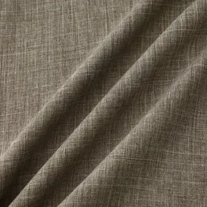 Detailed macro view showing the textured gray-brown cotton linen fabric of a men's shirt