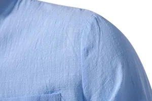 Close-up of light blue cotton linen shirt showing fabric texture and shoulder seam