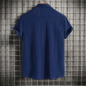 Close-up detail of the back of a navy blue men's casual short-sleeve shirt with texture
