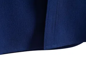 Detailed macro shot of navy blue shirt fabric showing texture and double-stitched hem finish