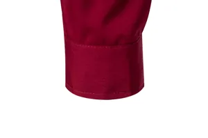 Detailed close-up of a burgundy men's shirt cuff showing clean stitching.