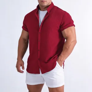 Casual slim fit men's dark red textured short-sleeve button-up shirt on a model