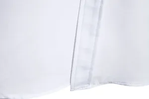 Macro detail showing the high-quality hem stitching and white fabric of a men's shirt