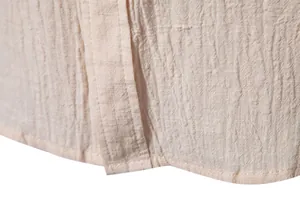 Detailed close-up of men's cotton linen shirt fabric showing textured weave and hem
